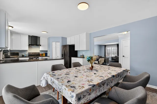 a kitchen with stainless steel appliances kitchen island granite countertop a sink and a refrigerator