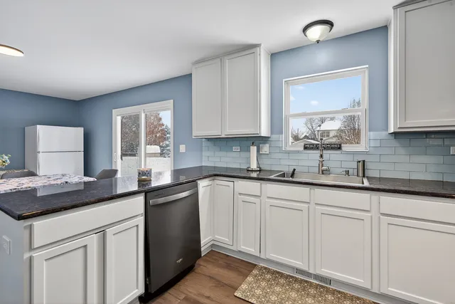 a kitchen with a sink stove and cabinets