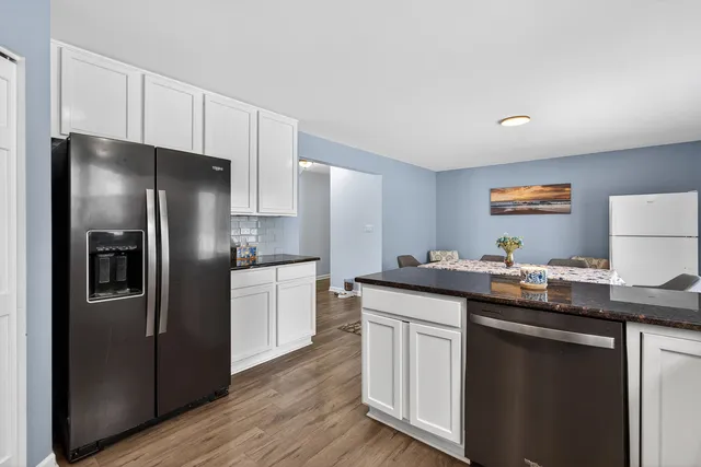 a kitchen with stainless steel appliances granite countertop a refrigerator and a sink