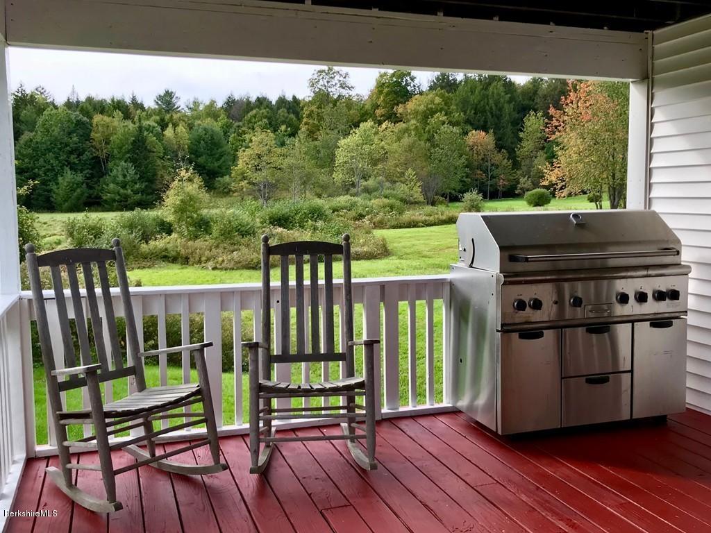 221 Number 9 Road Rowe, MA 01367 - Photo 4 of 27 a view of a deck with wooden floor and outdoor seating