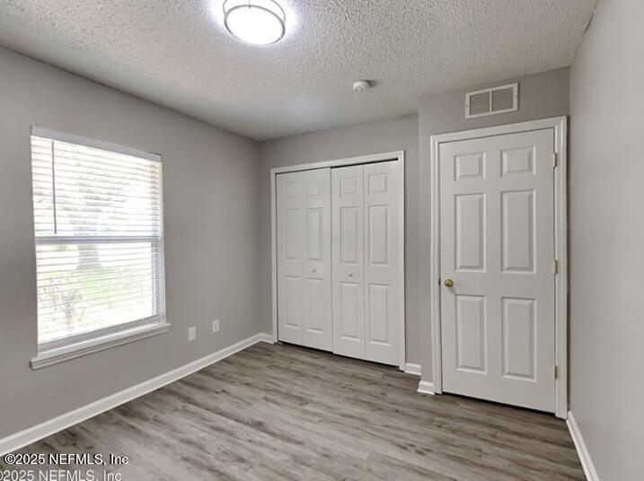 844 MacKenzie Circle St. Augustine, FL 32092 - Photo 13 of 20 an empty room with wooden floor and windows