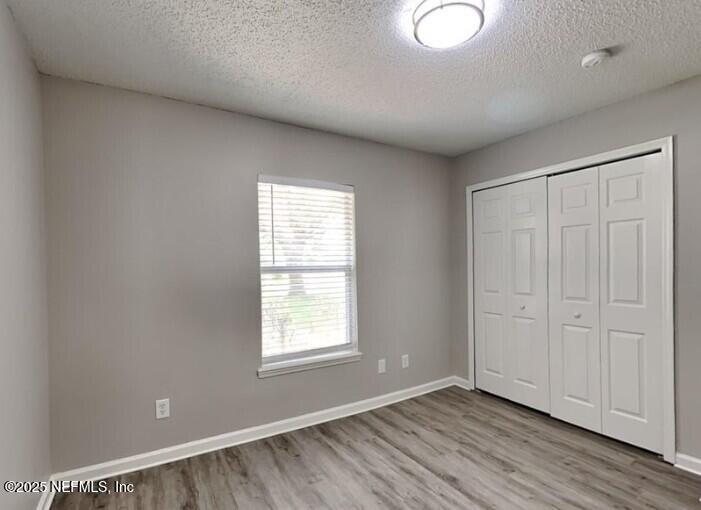 844 MacKenzie Circle St. Augustine, FL 32092 - Photo 14 of 20 an empty room with wooden floor and windows