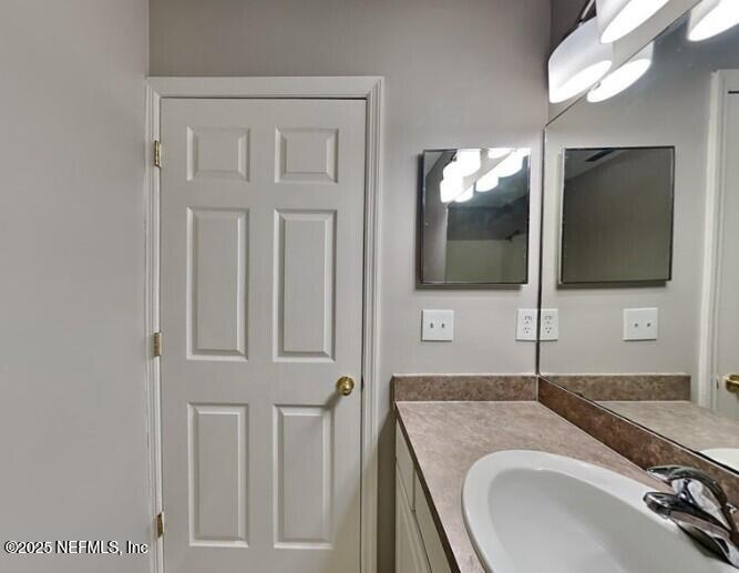 844 MacKenzie Circle St. Augustine, FL 32092 - Photo 15 of 20 a bathroom with a sink a vanity and mirror