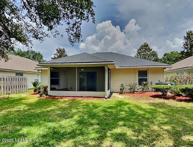 844 MacKenzie Circle St. Augustine, FL 32092 - Photo 18 of 20 a front view of a house with a garden and plants