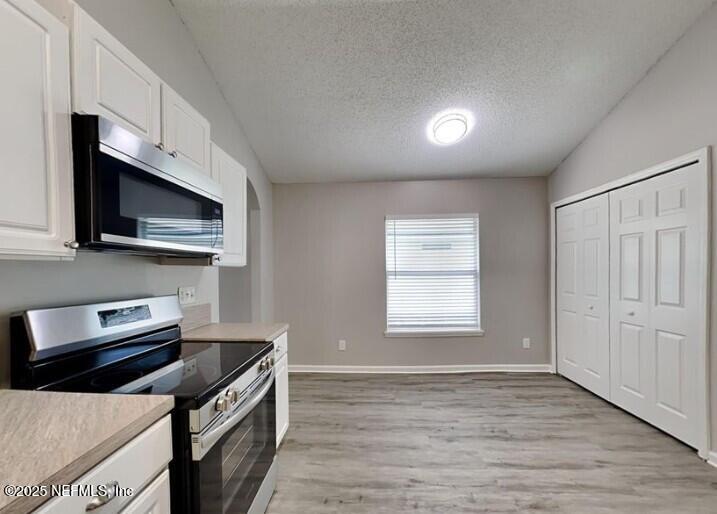 844 MacKenzie Circle St. Augustine, FL 32092 - Photo 5 of 20 a kitchen with stainless steel appliances a stove microwave and sink