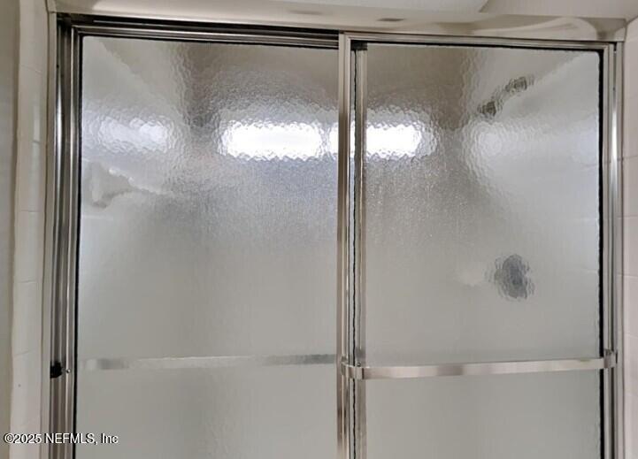844 MacKenzie Circle St. Augustine, FL 32092 - Photo 10 of 20 a bathroom with a glass shower door