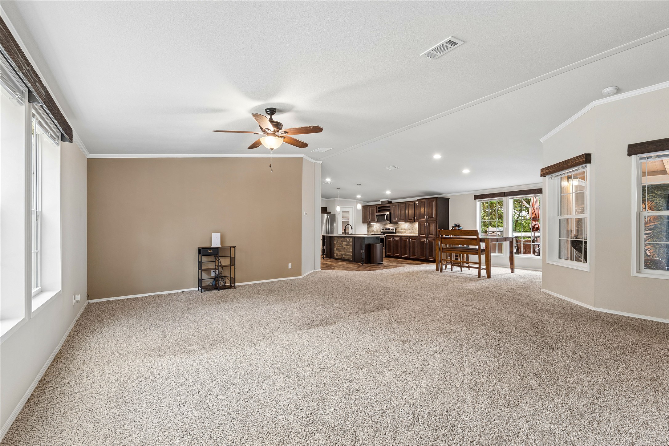 1024 Sand Hills Road Red Rock, TX 78662 - Photo 5 of 40 Living area featuring an open layout, carpet and a ceiling fan