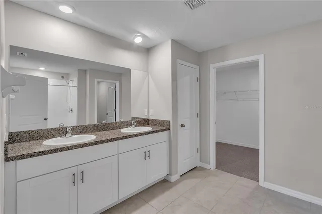 a bathroom with a shower a toilet and a sink