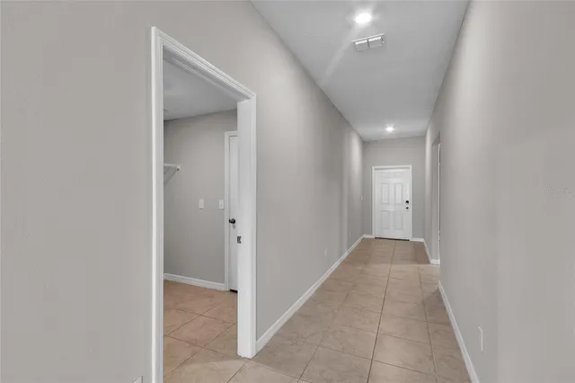 an empty room with a ceiling fan and a window