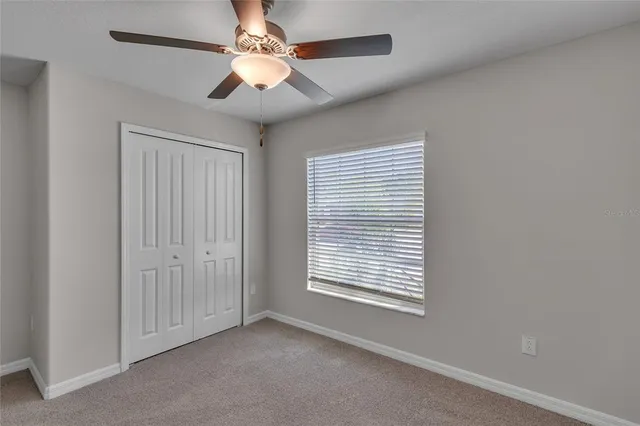 a bathroom with a granite countertop sink toilet mirror and shower