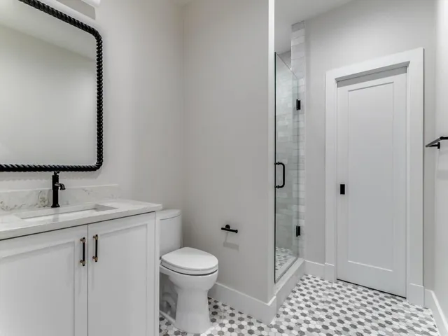 a bathroom with a toilet a sink and mirror
