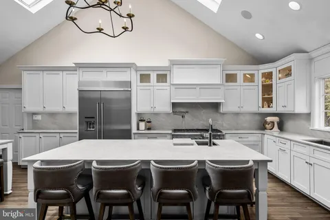 a kitchen with stainless steel appliances granite countertop a sink and cabinets