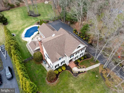 an aerial view of a house with garden space and street view