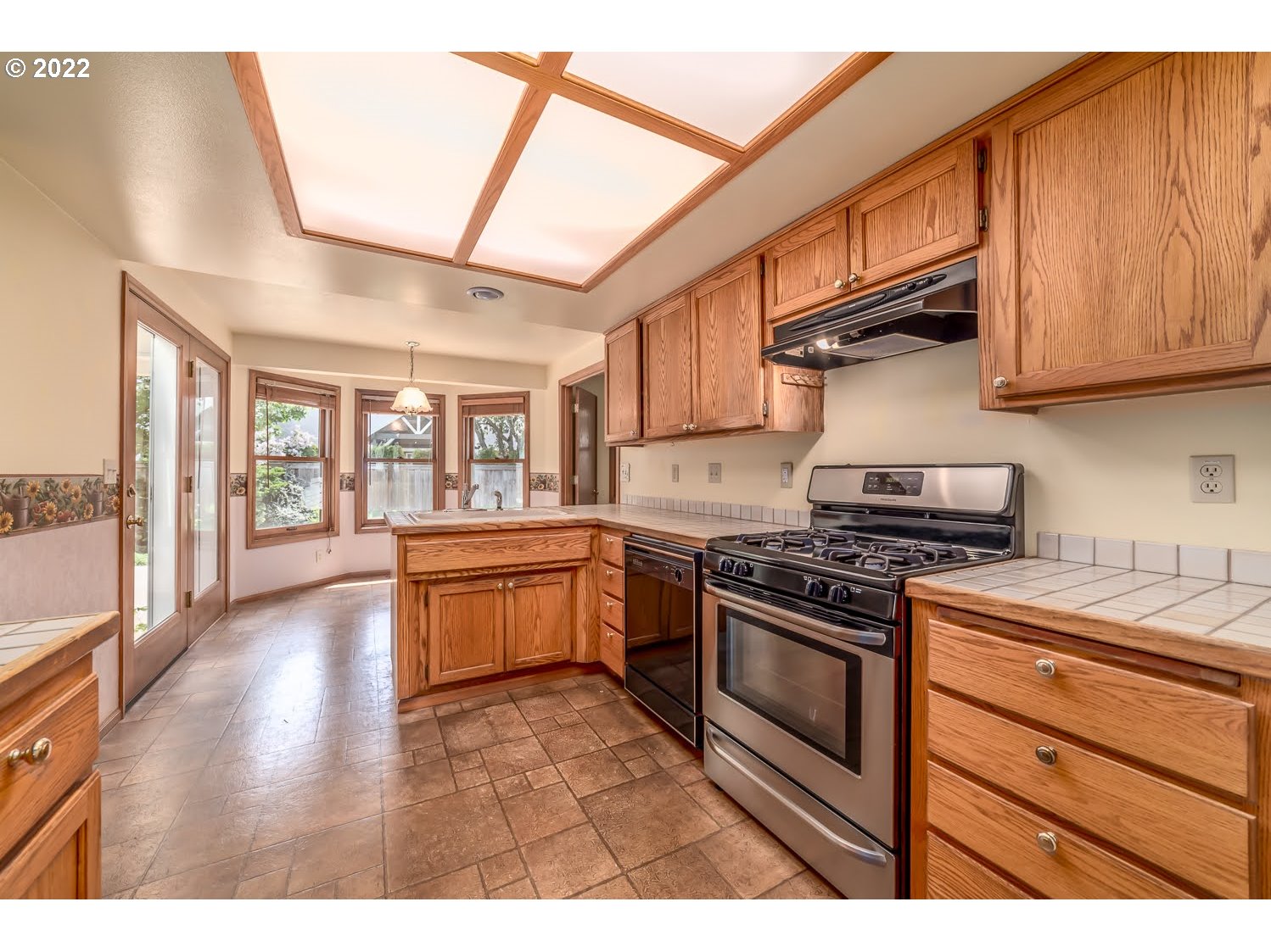 3166 W Street Springfield, OR 97477 - Photo 12 of 32 a kitchen with stainless steel appliances granite countertop a stove and a wooden cabinets