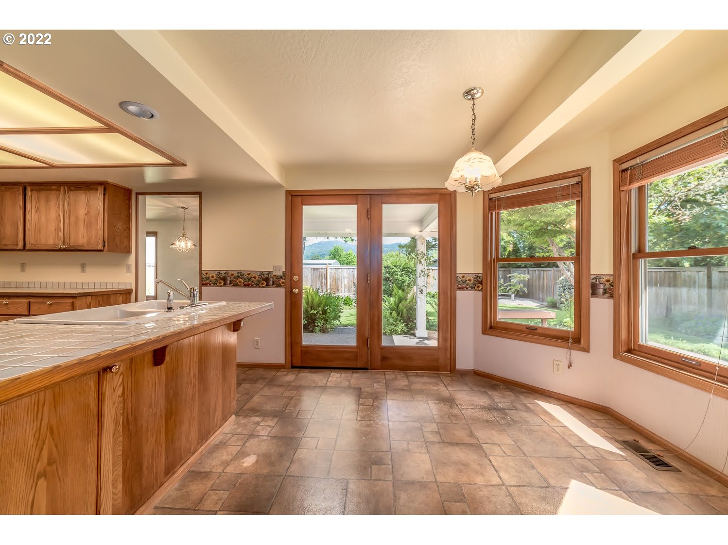 3166 W Street Springfield, OR 97477 - Photo 13 of 32 a open kitchen with stainless steel appliances granite countertop a stove top oven a sink dishwasher and cabinets with wooden floor