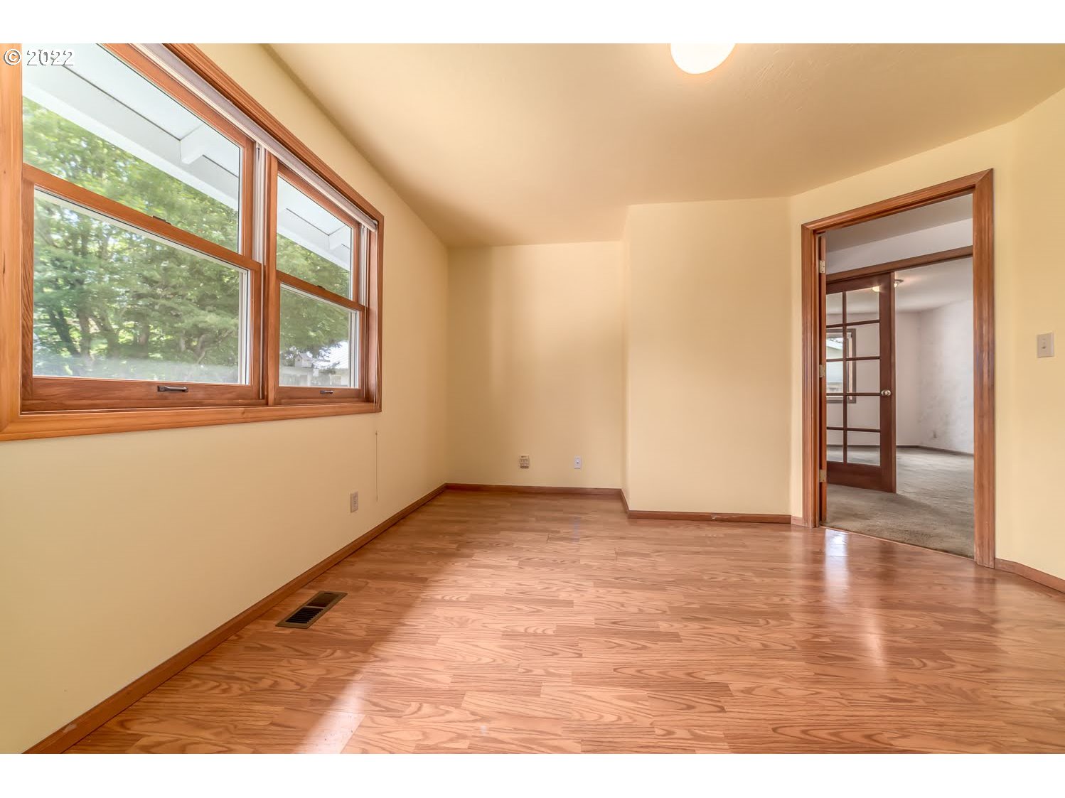 3166 W Street Springfield, OR 97477 - Photo 17 of 32 an empty room with wooden floor and windows