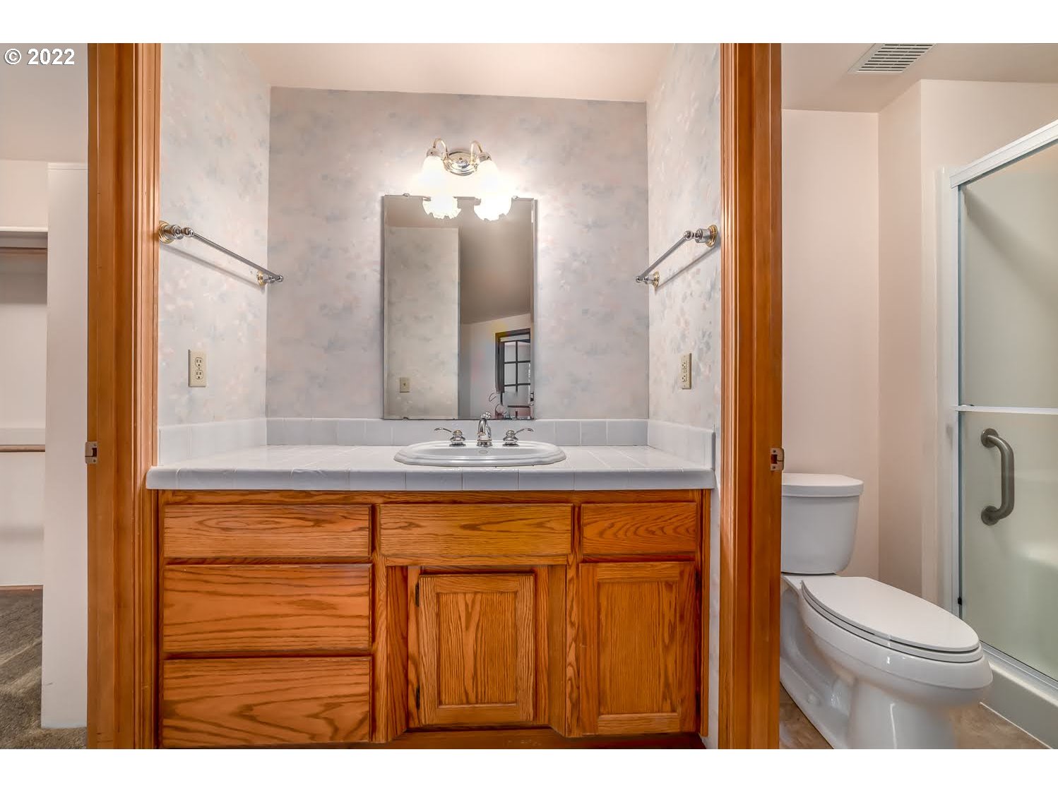 3166 W Street Springfield, OR 97477 - Photo 20 of 32 a bathroom with a sink a toilet and a mirror