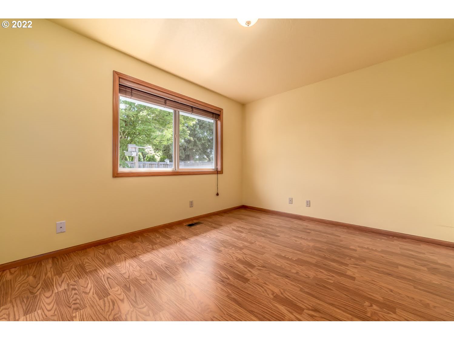 3166 W Street Springfield, OR 97477 - Photo 23 of 32 a view of an empty room with wooden floor and a window