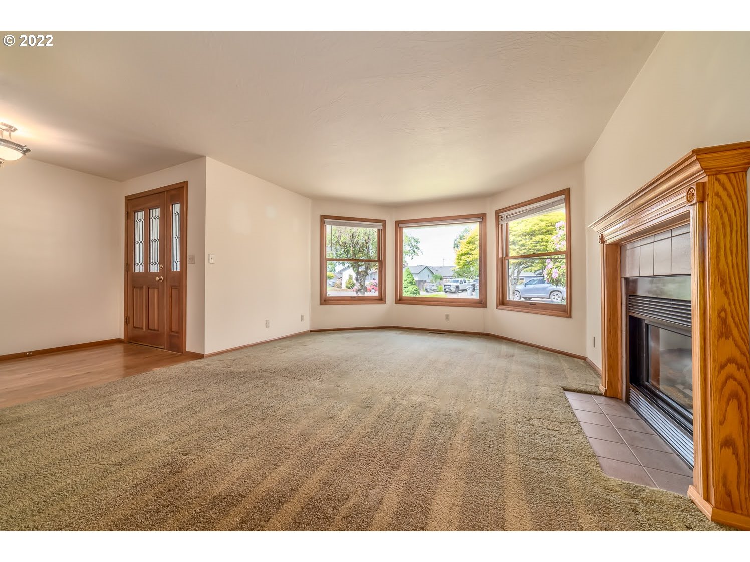 3166 W Street Springfield, OR 97477 - Photo 6 of 32 a view of an empty room with a window and a fireplace