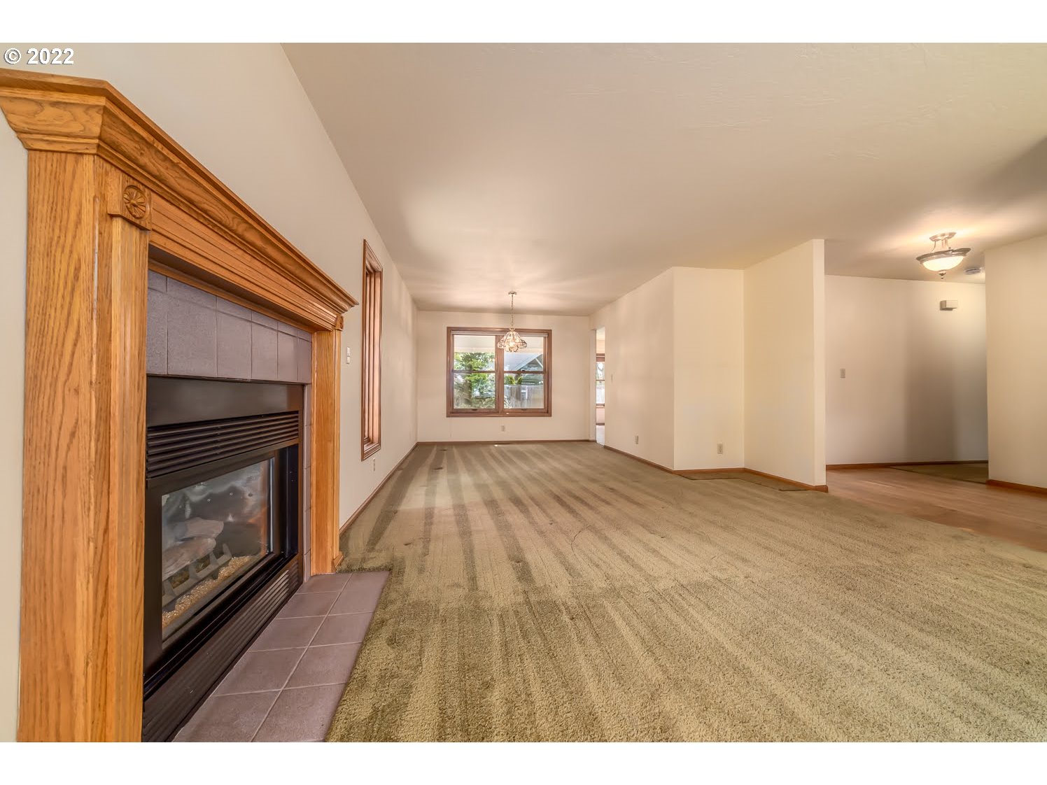 3166 W Street Springfield, OR 97477 - Photo 7 of 32 a view of an empty room with a fireplace and a window