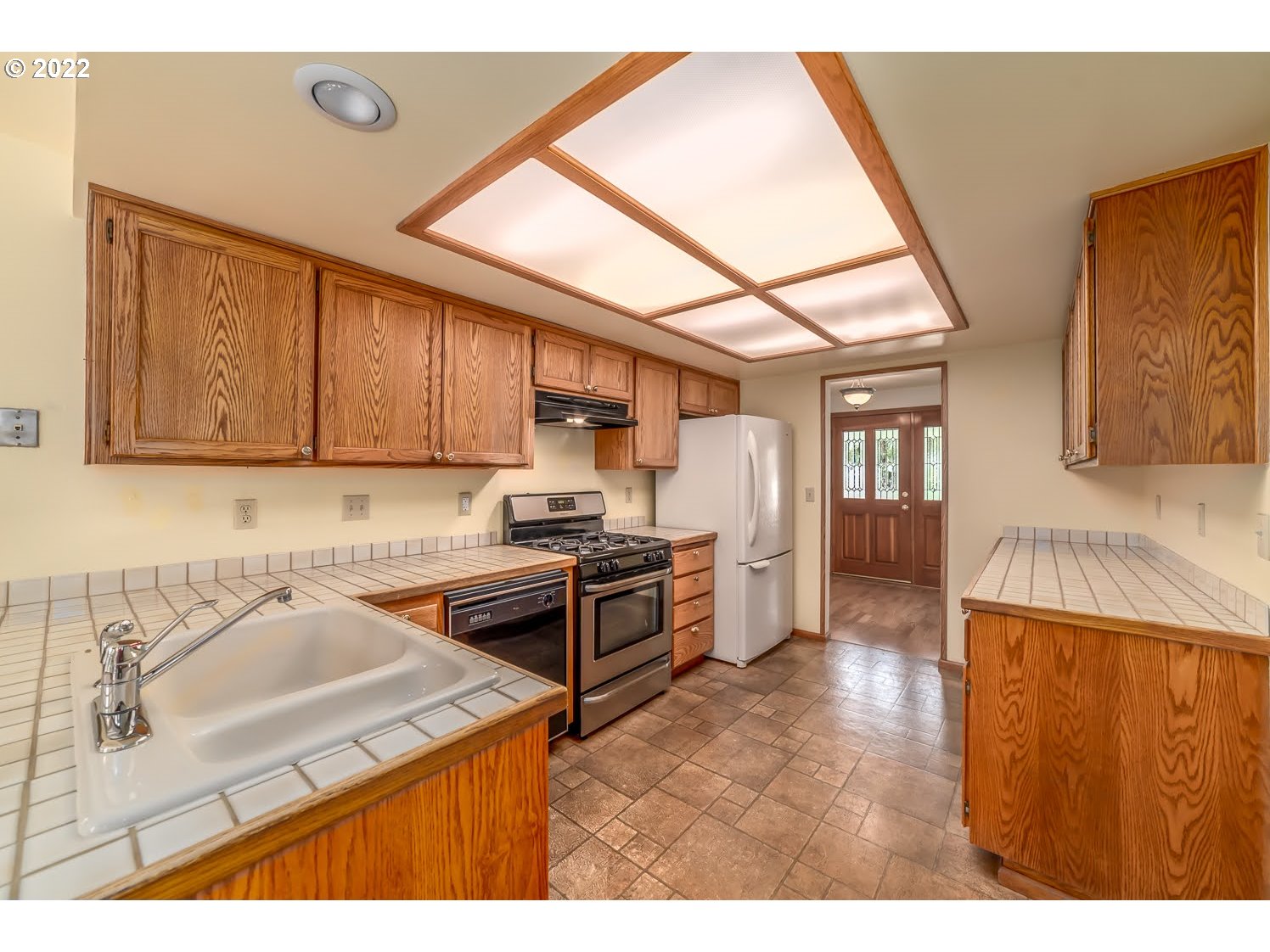 3166 W Street Springfield, OR 97477 - Photo 10 of 32 a kitchen with stainless steel appliances granite countertop a sink stove and refrigerator