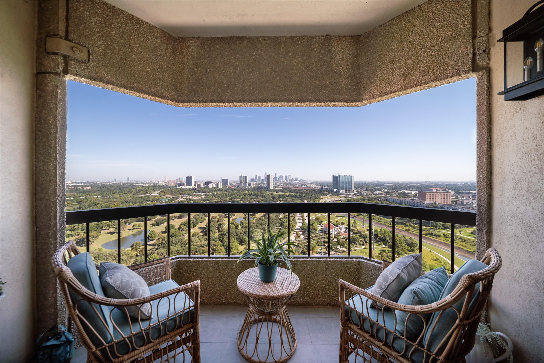 a balcony with couch and chairs
