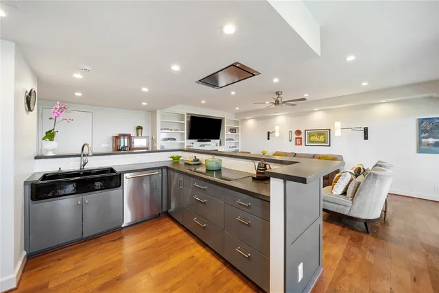 a kitchen with stainless steel appliances kitchen island granite countertop a sink and cabinets