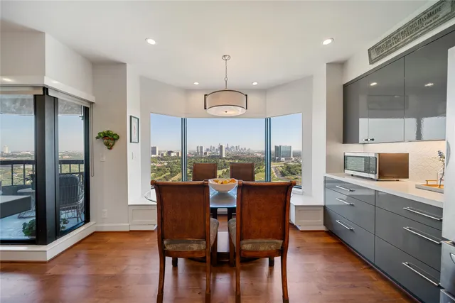 a dining room with furniture a chandelier and wooden floor