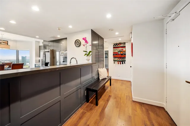 a kitchen with stainless steel appliances granite countertop a refrigerator and a sink