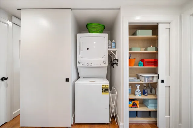 a living room with stainless steel appliances furniture and a flat screen tv