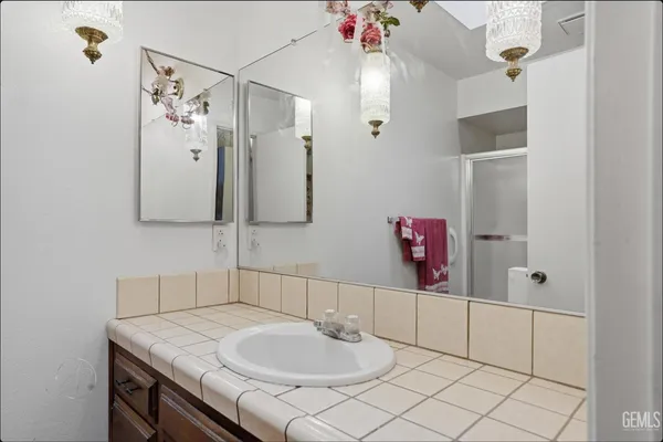 a bathroom with a sink vanity and a mirror