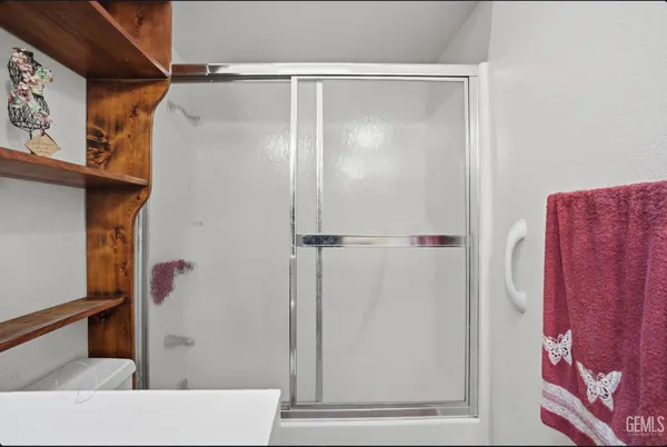 a bathroom with a shower and a sink