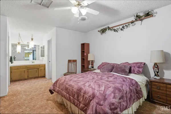 a bed room with a bed and a chandelier