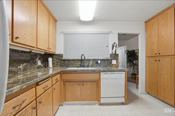 a kitchen with stainless steel appliances granite countertop a sink and cabinets