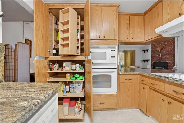 a kitchen with stainless steel appliances granite countertop a stove and cabinets