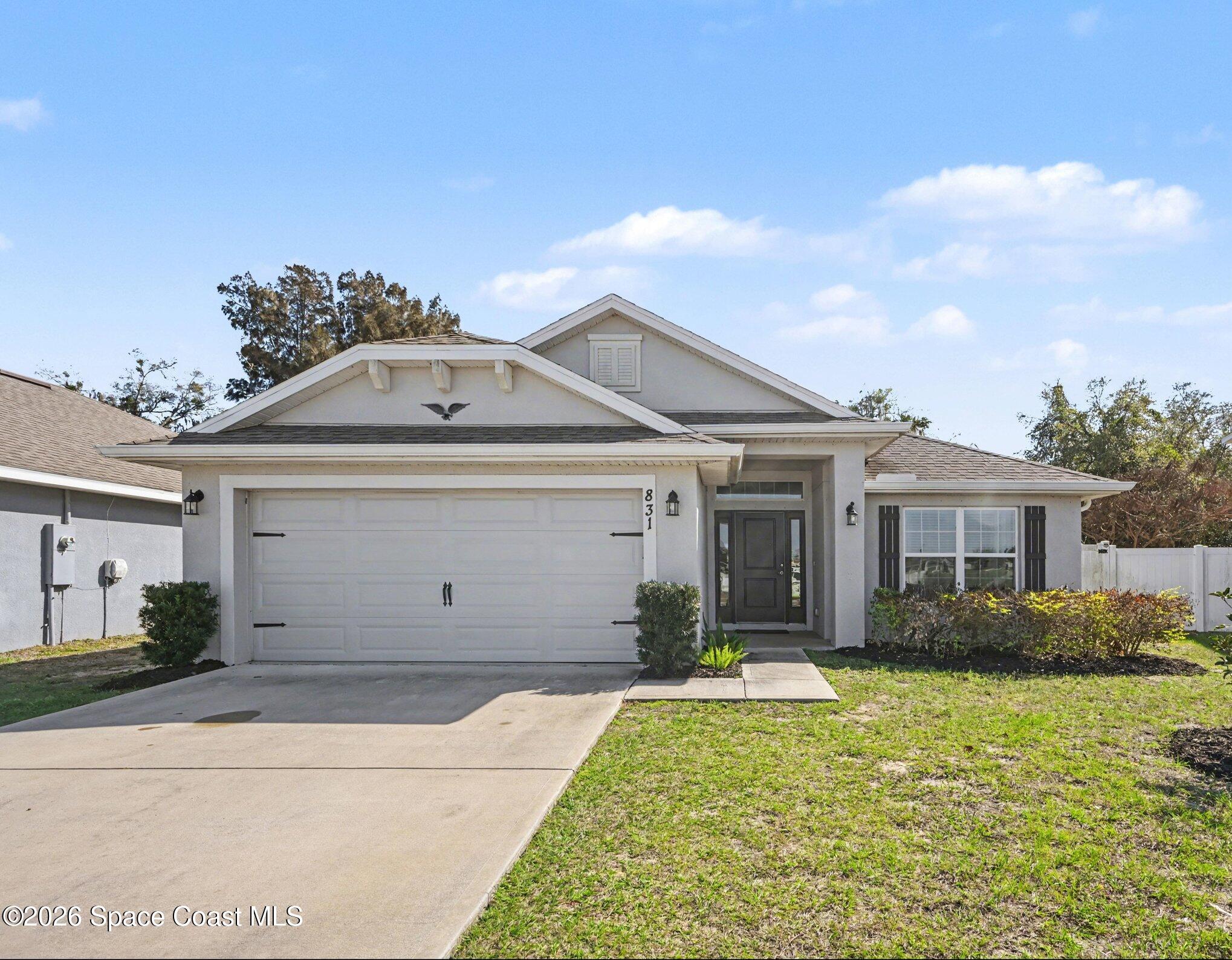 831 Tupelo Circle Cocoa, FL 32926 - Photo 1 of 23 a front view of a house with garden