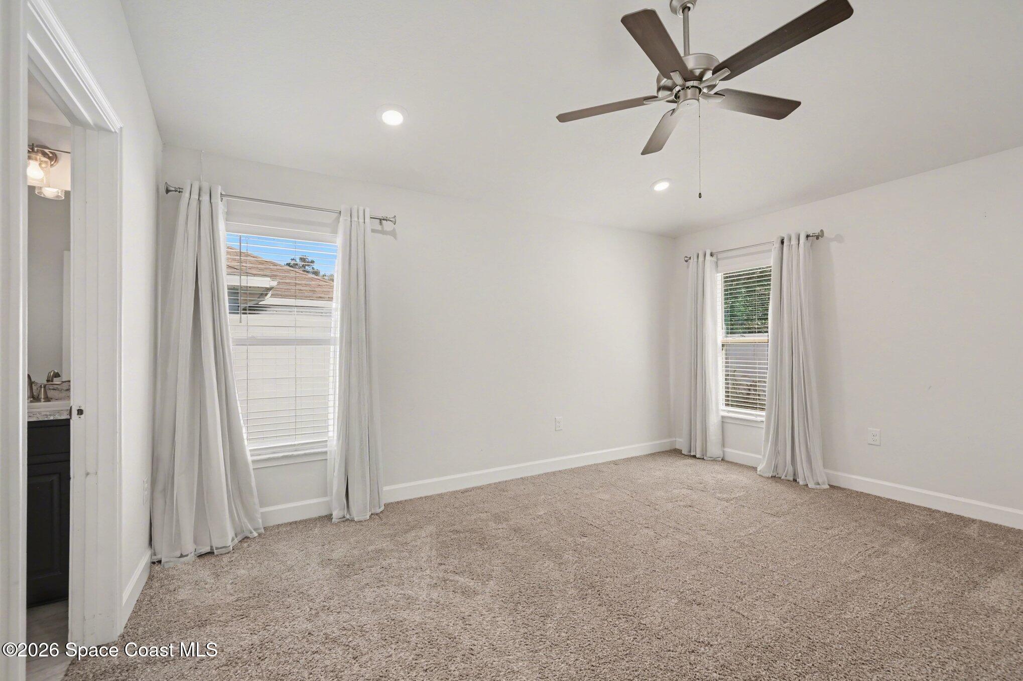 831 Tupelo Circle Cocoa, FL 32926 - Photo 14 of 23 an empty room with closet and a ceiling fan