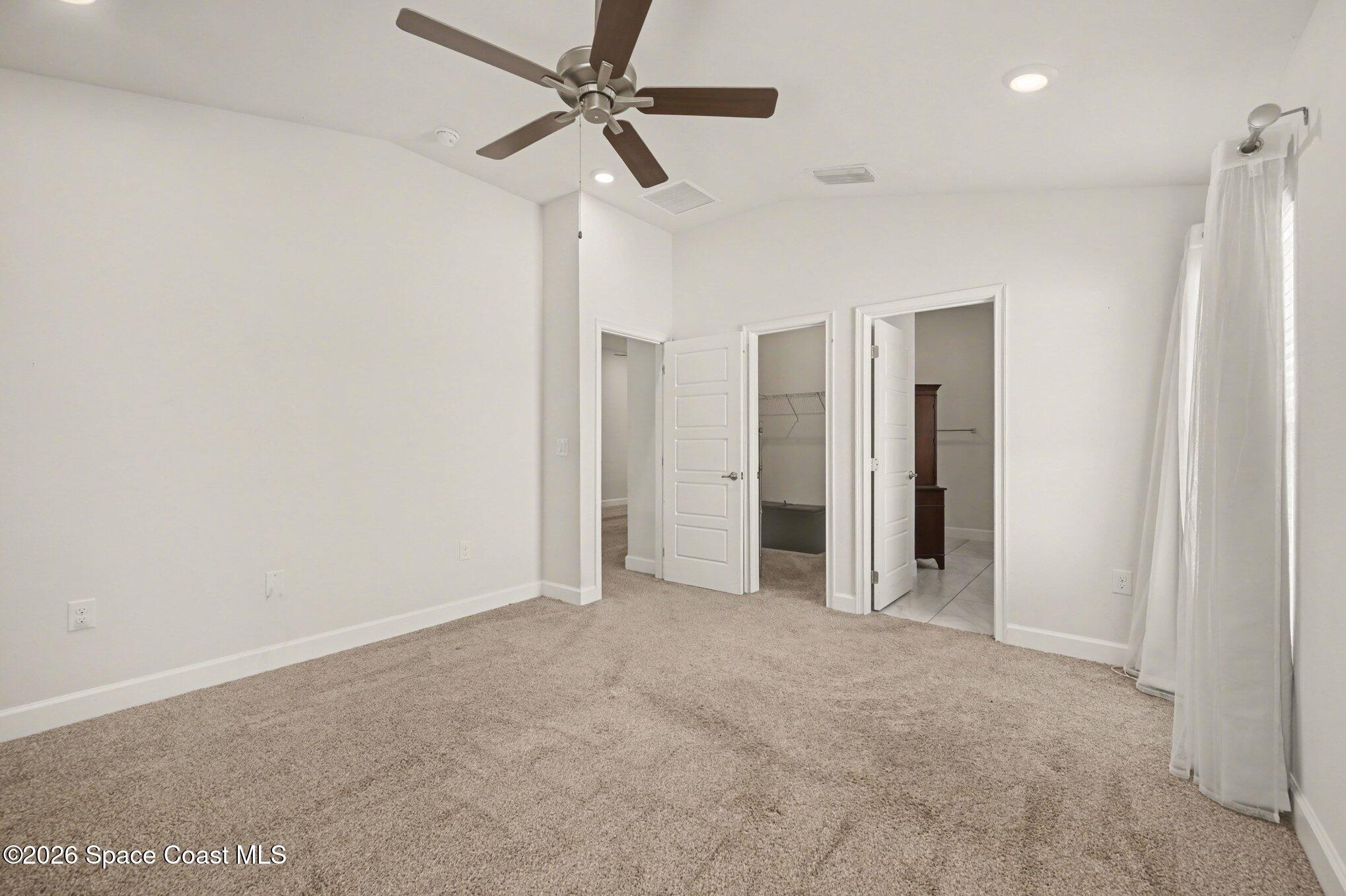 831 Tupelo Circle Cocoa, FL 32926 - Photo 15 of 23 an empty room with closet and a ceiling fan