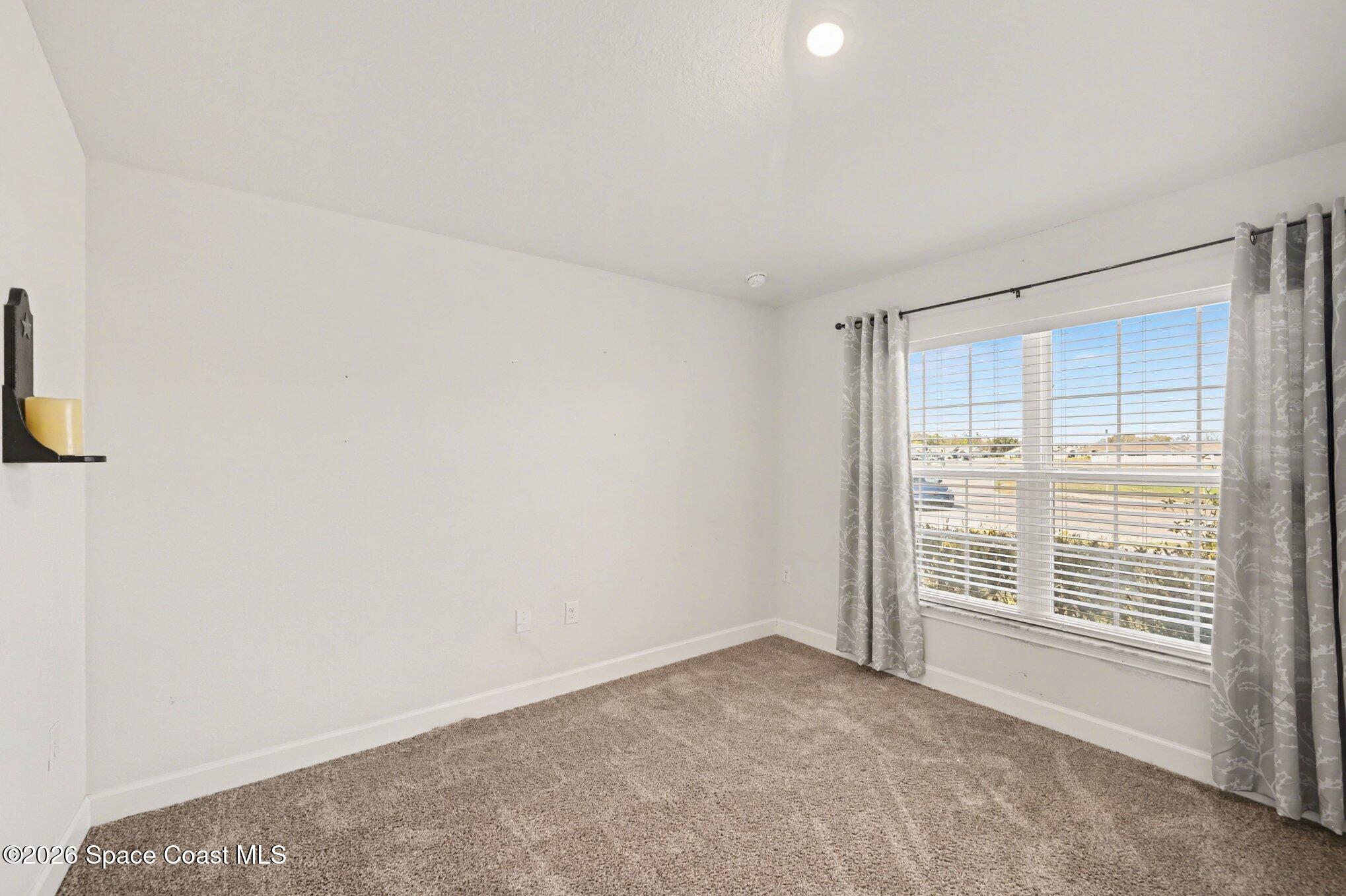 831 Tupelo Circle Cocoa, FL 32926 - Photo 19 of 23 a view of an empty room with a window