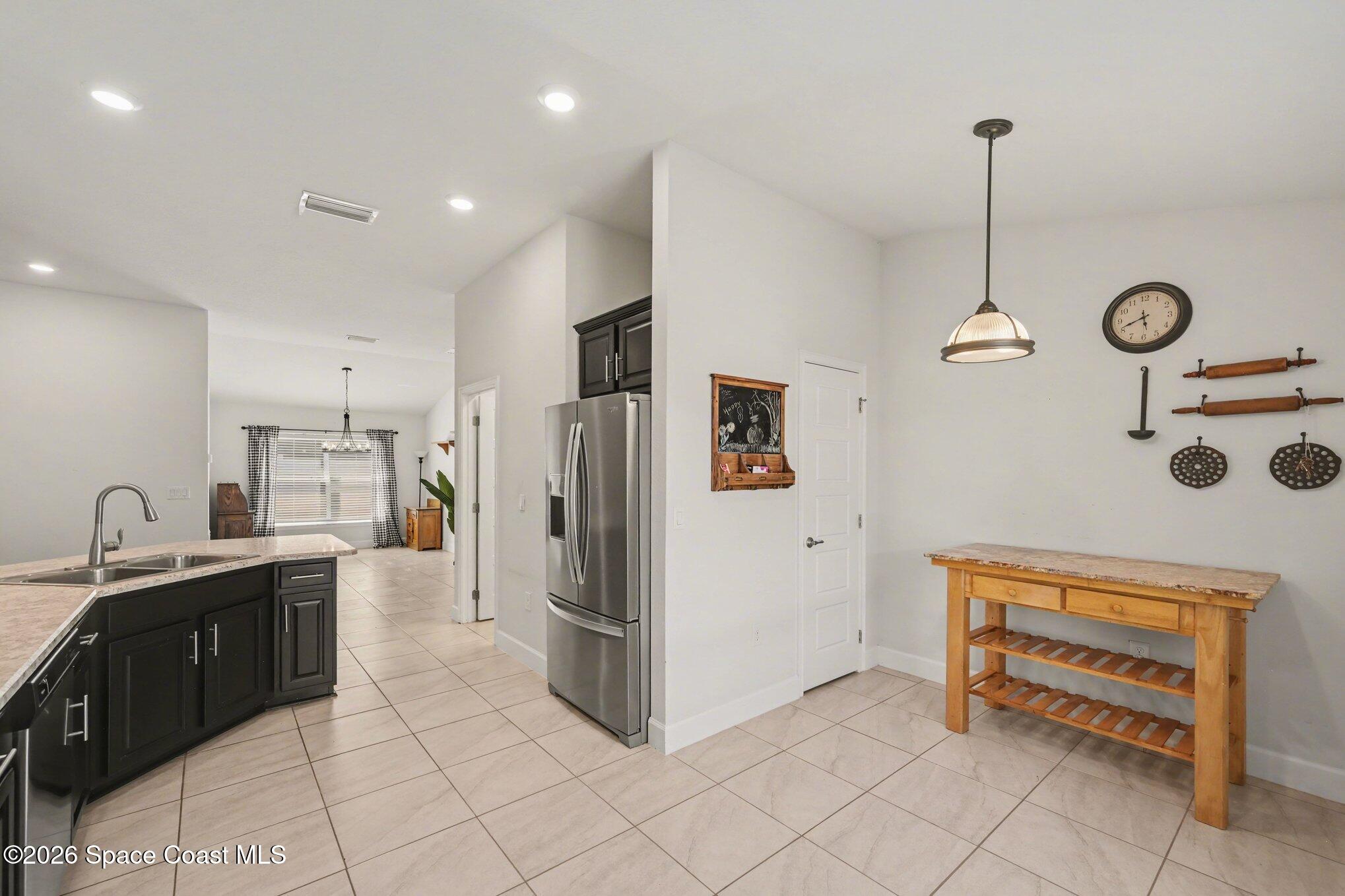 831 Tupelo Circle Cocoa, FL 32926 - Photo 6 of 23 a kitchen with stainless steel appliances a refrigerator sink and cabinets