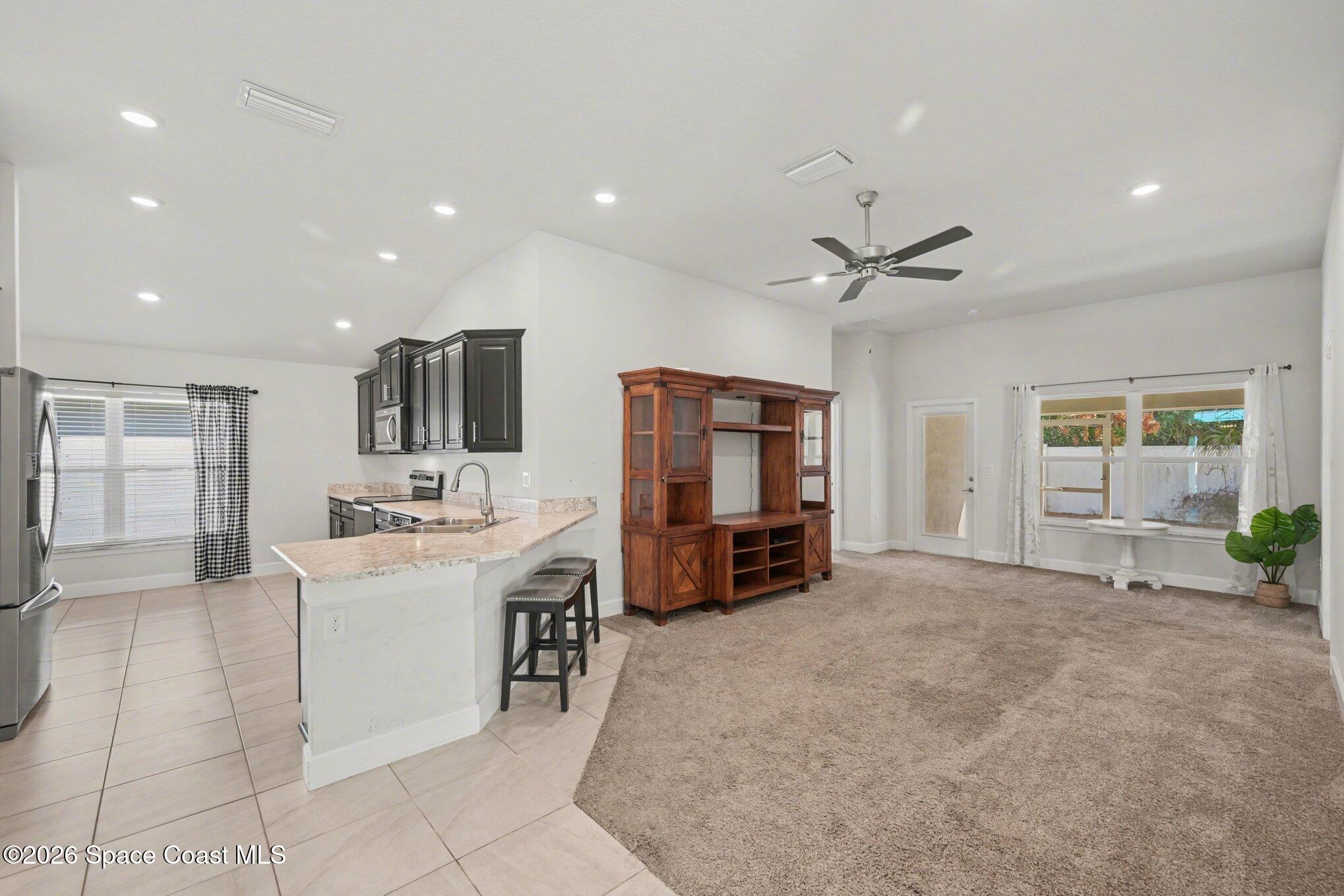 831 Tupelo Circle Cocoa, FL 32926 - Photo 8 of 23 a view of a livingroom with furniture window and a kitchen