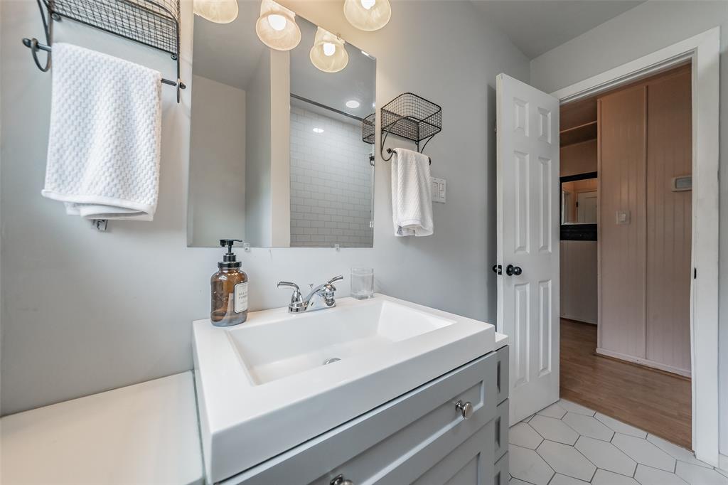 1802 Keneipp Road Carrollton, TX 75006 - Photo 11 of 22 Bathroom vanity with a white rectangular sink, chrome faucet, and grey cabinet
