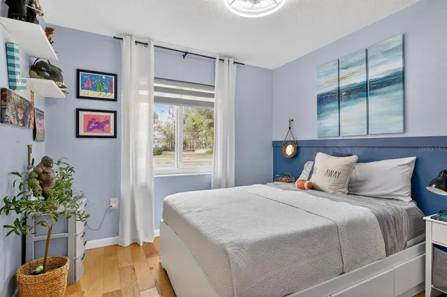 a bedroom with a bed and a potted plant