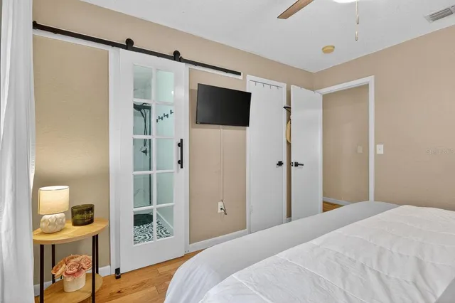 a bedroom with a bed and a flat screen tv