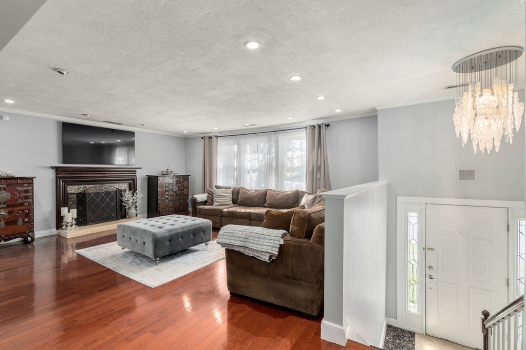 55 Glover Road Needham, MA 02494 - Photo 11 of 22 a living room with furniture and a fireplace