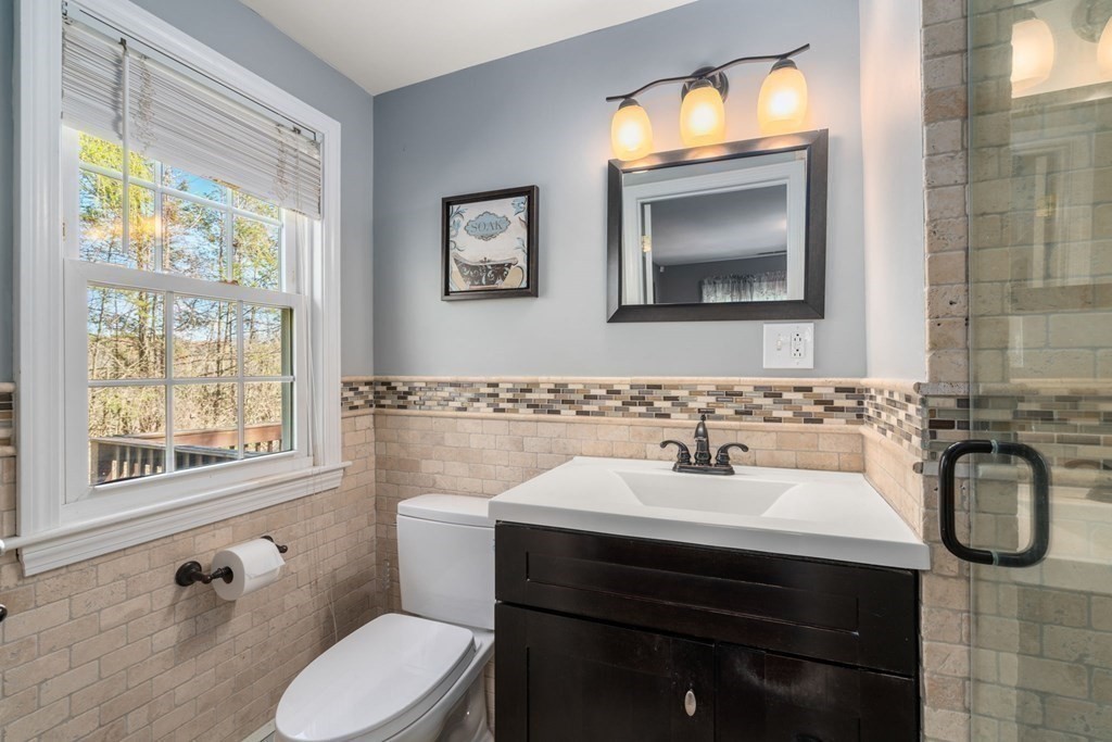 55 Glover Road Needham, MA 02494 - Photo 15 of 22 a bathroom with a sink a toilet and a mirror