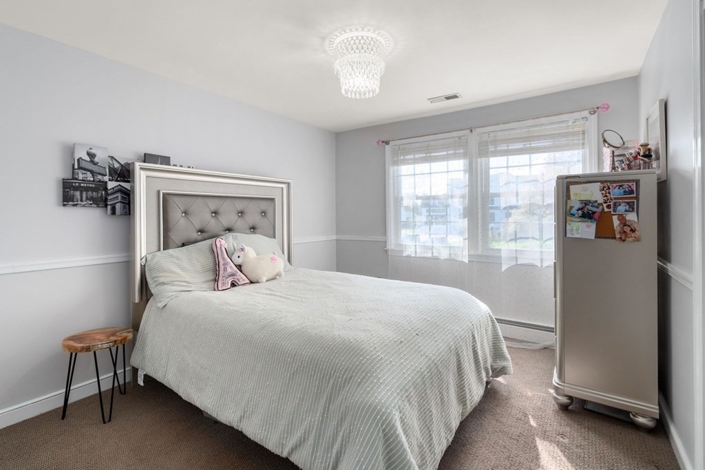 55 Glover Road Needham, MA 02494 - Photo 16 of 22 a bedroom with a bed and a window