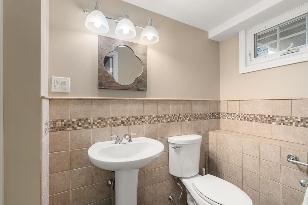 55 Glover Road Needham, MA 02494 - Photo 18 of 22 a bathroom with a toilet sink and mirror