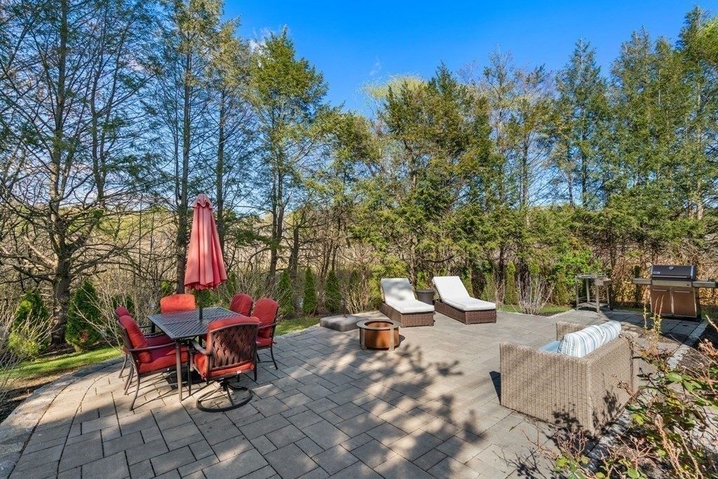 55 Glover Road Needham, MA 02494 - Photo 20 of 22 a view of a tables and chairs on the fire pit