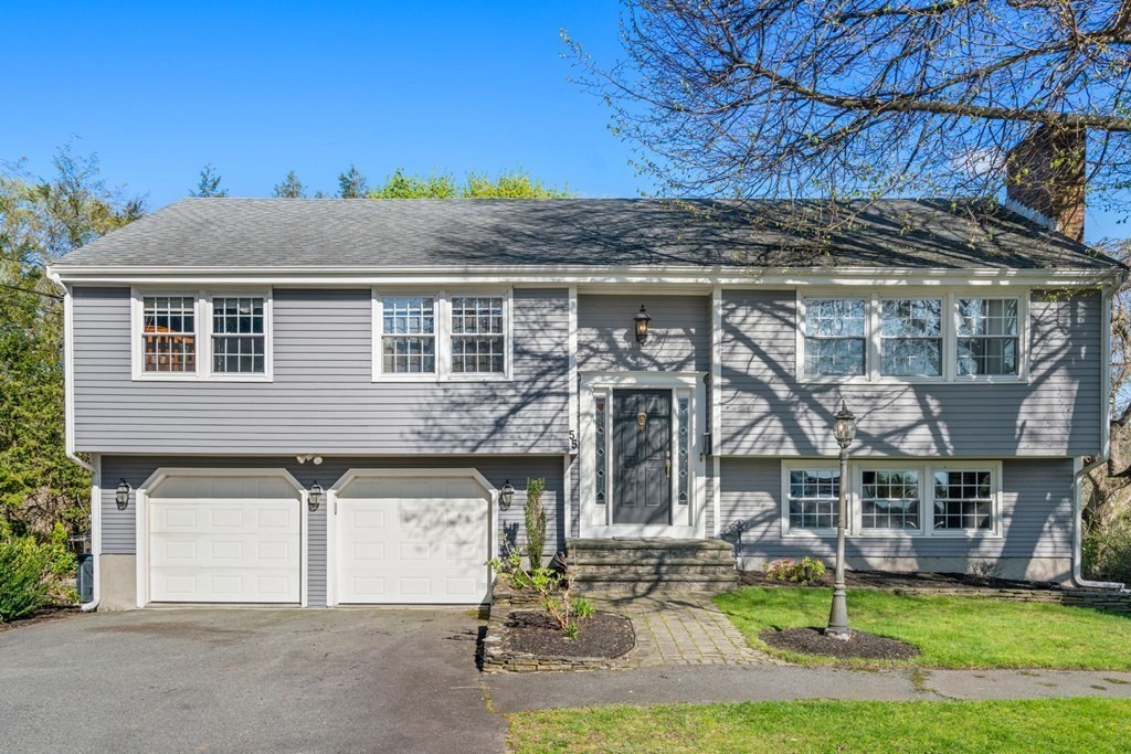 55 Glover Road Needham, MA 02494 - Photo 2 of 22 a front view of a house with garden